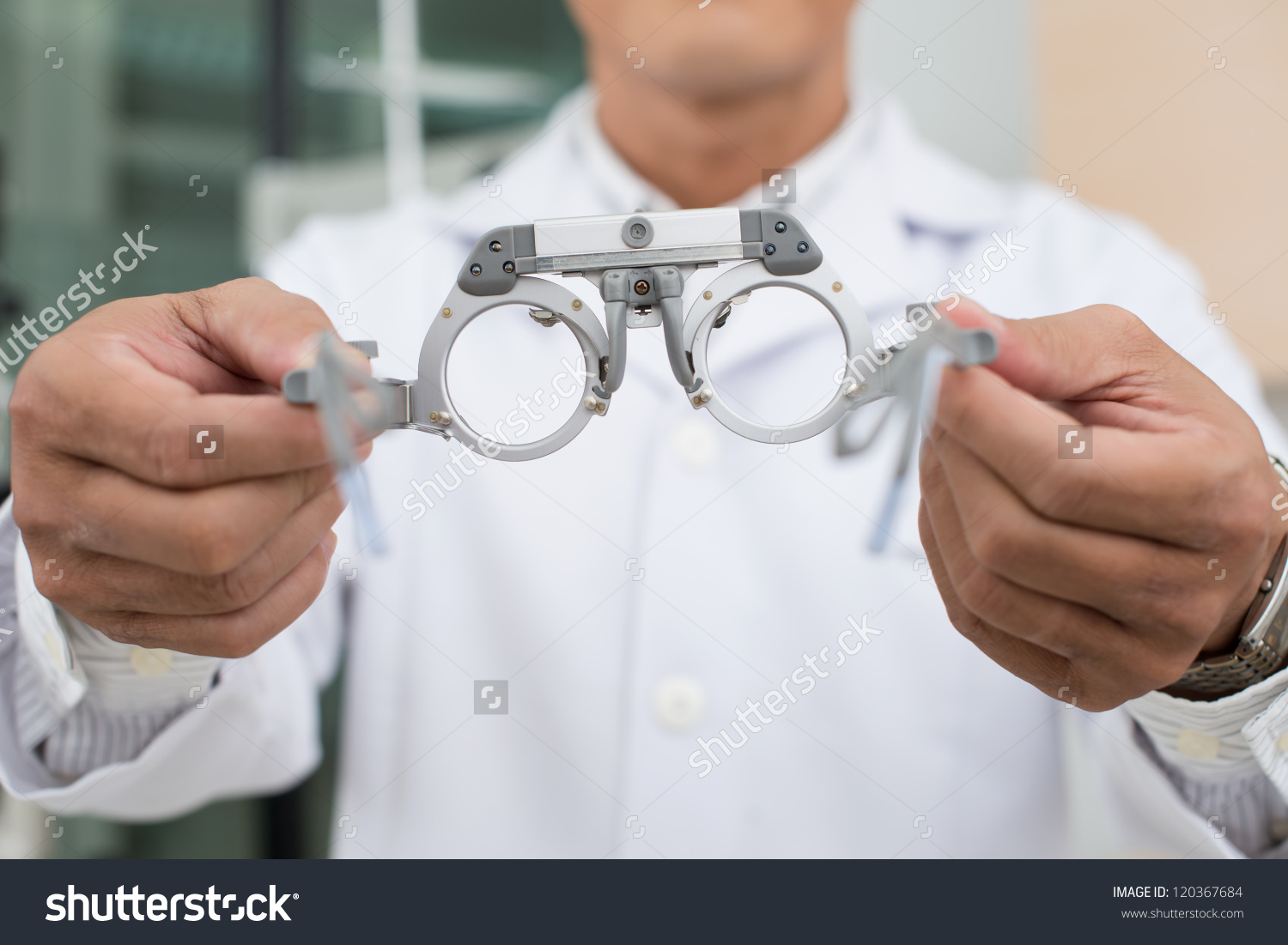 stockphotocloseupofopticianreachingoutglassestopatient